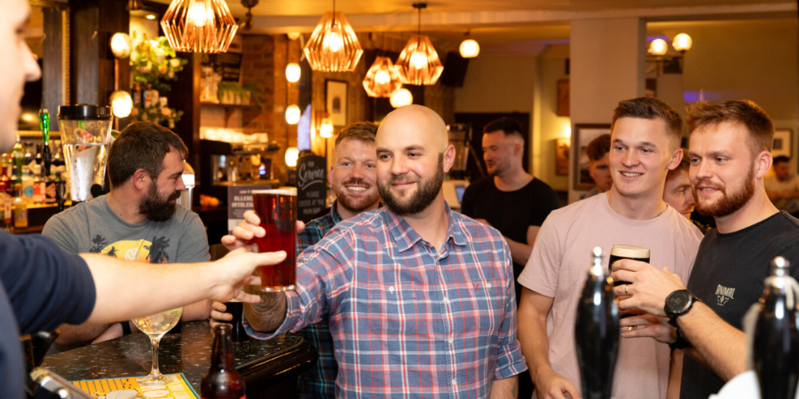 Group of guys enjoying drinks in the pub