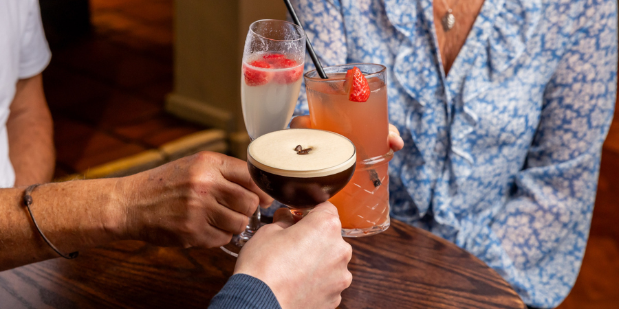 3 people cheersing drinks