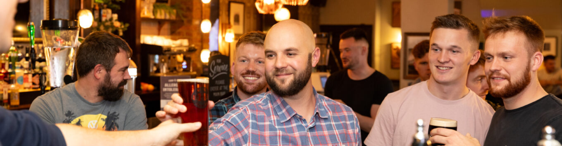 Group of guys enjoying drinks in the pub
