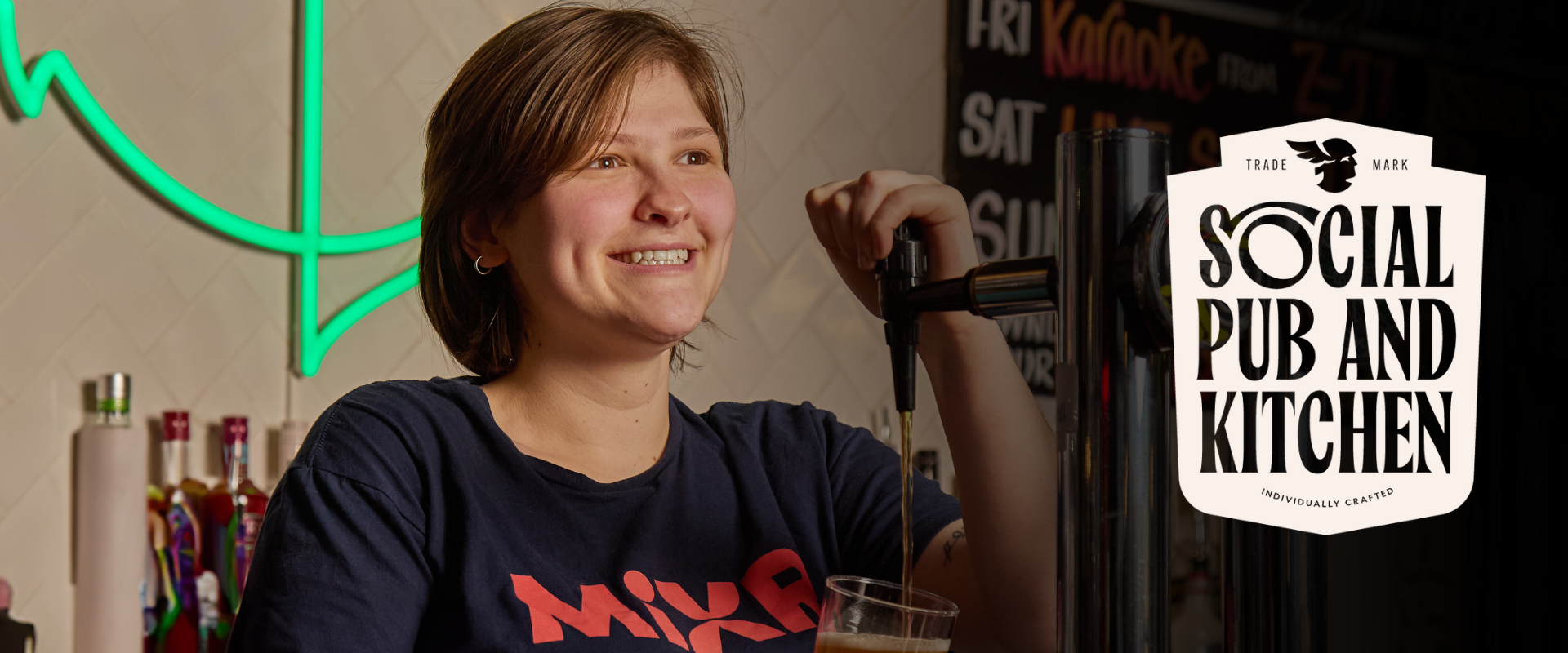Bar team member pouring a pint