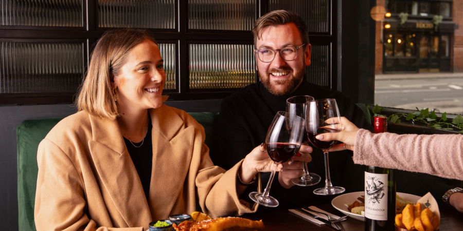 Group with red wine and meals at The Chapter Collection