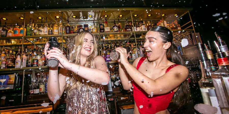 Girls making cocktails at a cocktail making masterclass