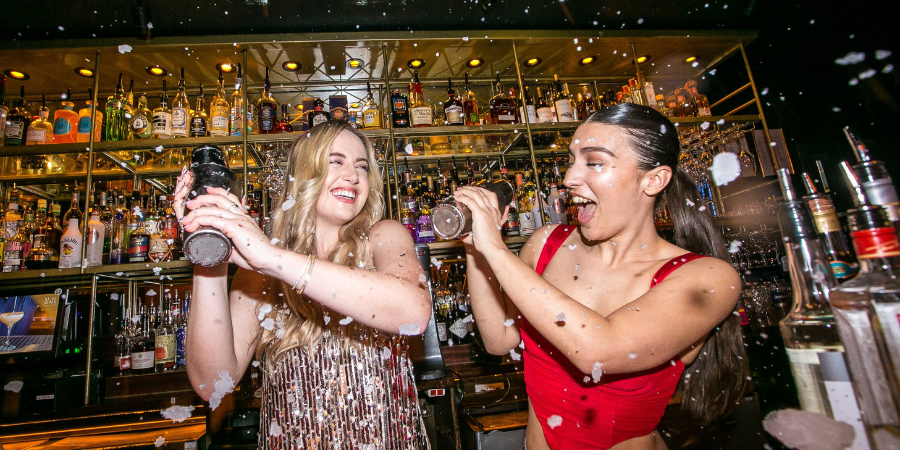 Girls mixing cocktails at Be At One