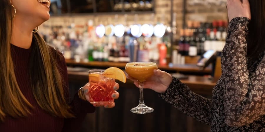 Toasting drinks at the bar