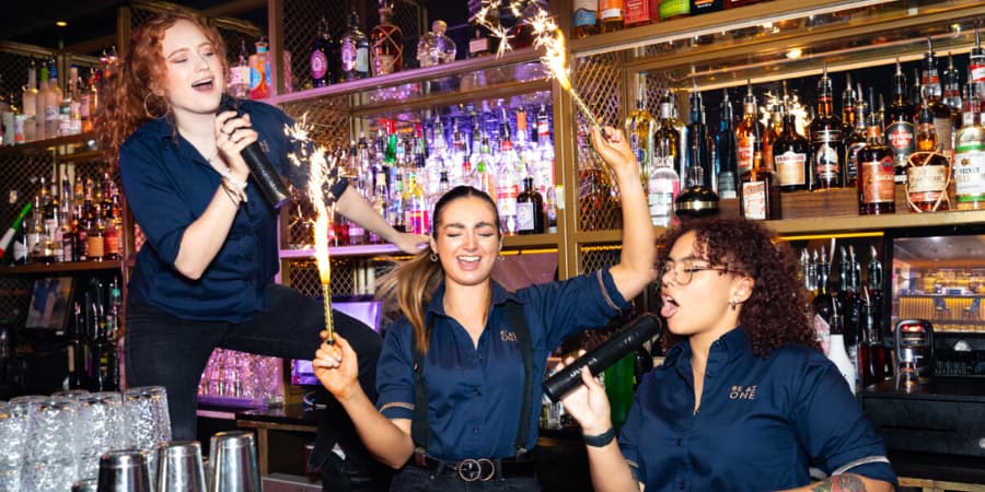 3 Be at One bartenders behind the bar