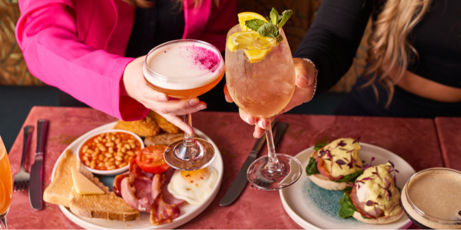 Girls toasting to their bottomless brunch in London Girls toasting to their bottomless brunch in London