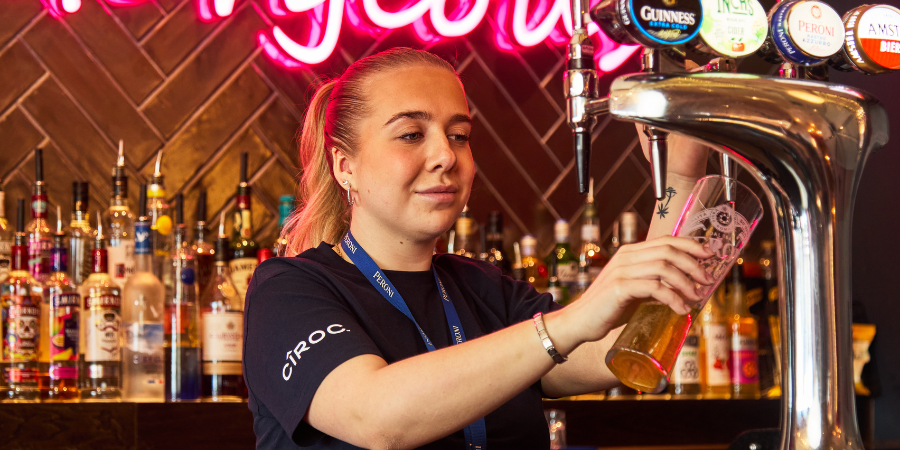 S&L Team Member pouring a pint