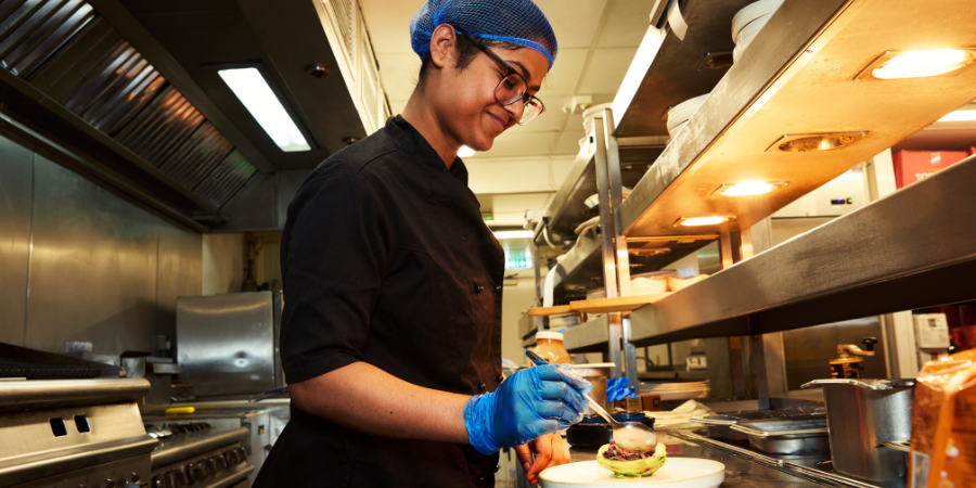 Kitchen Team Member plating up a dish
