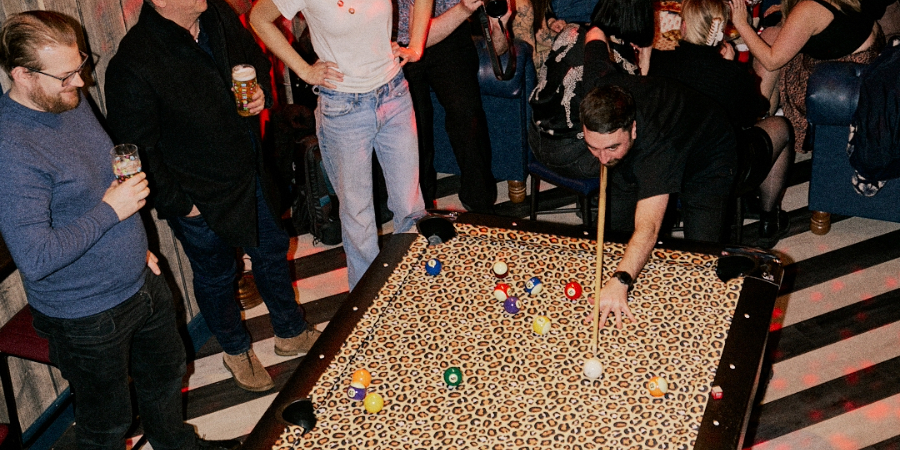 Man cueing up to play pool at Rita's