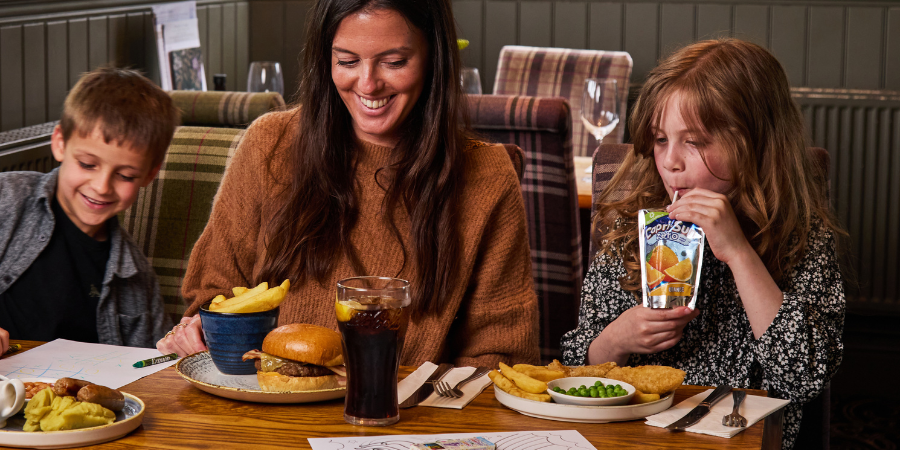 2 kids and their parent enjoying a meal