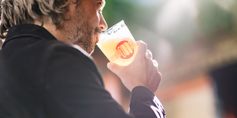 Man drinking pint at The Chapter Collection