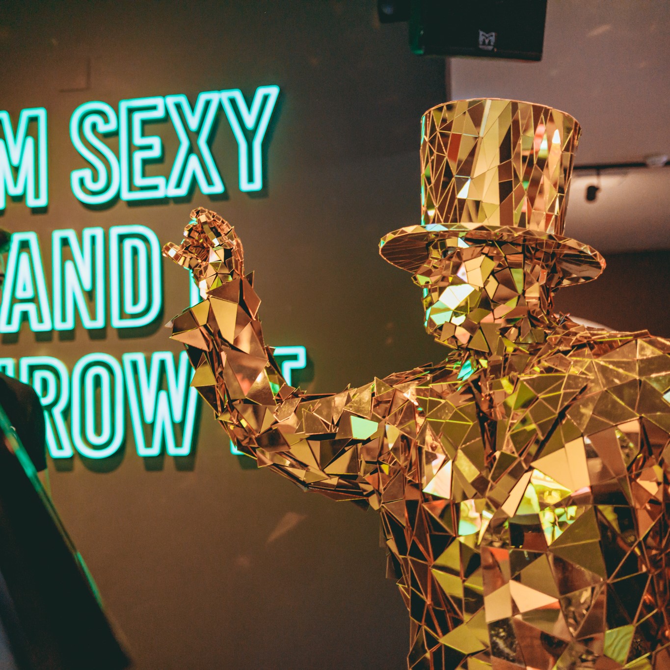 Golden figure in top hat playing interactive darts