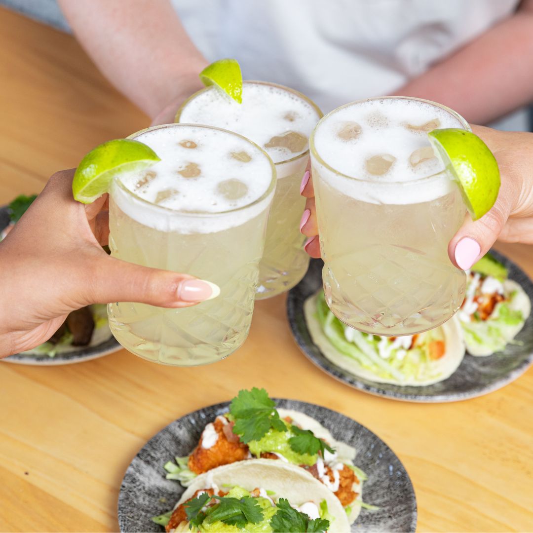 Selection of tommy margarita's and chicken taco at your local Crafted Social pub