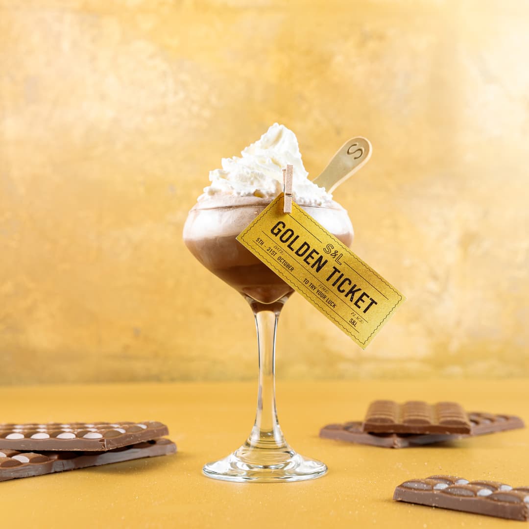 The Golden Ticket in front of gold background at Slug And Lettuce Piccadilly