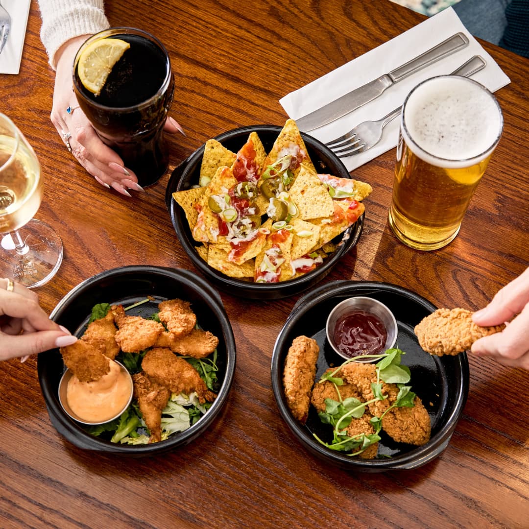 3 small plates: Chicken Goujons, Crispy Coated Prawns and Dorito's Loaded Nachos