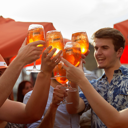 Group of friends drinking Aperol spritzes
