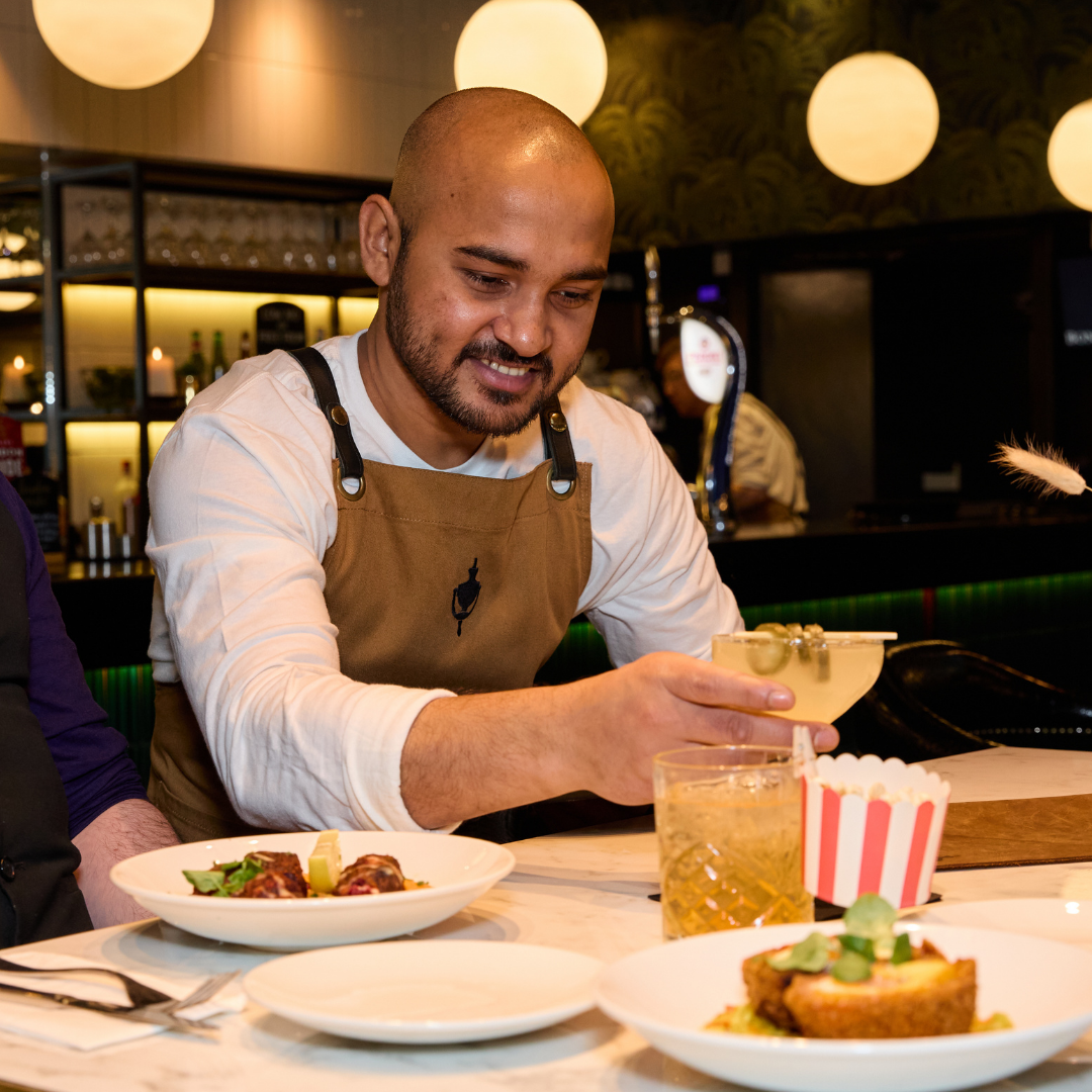 Front of House team member serving a table