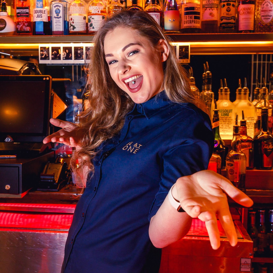 Female duty manager smiling at the camera.