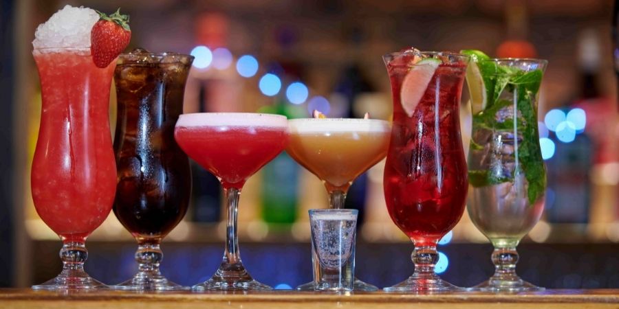 Various Cocktails Lined Up on Bar