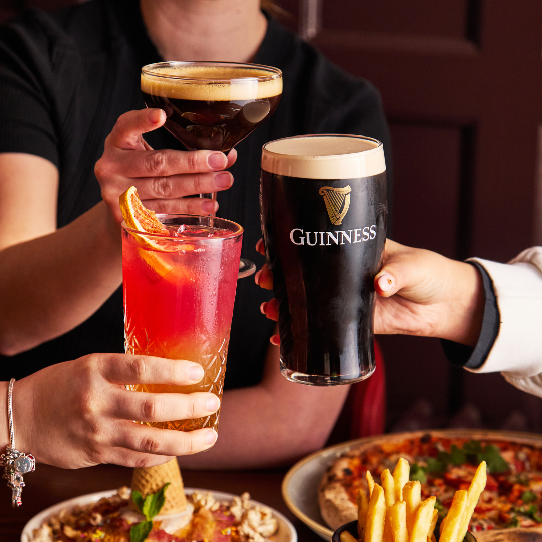 3 PEOPLE CHEERSING DRINKS AT BRUNCH