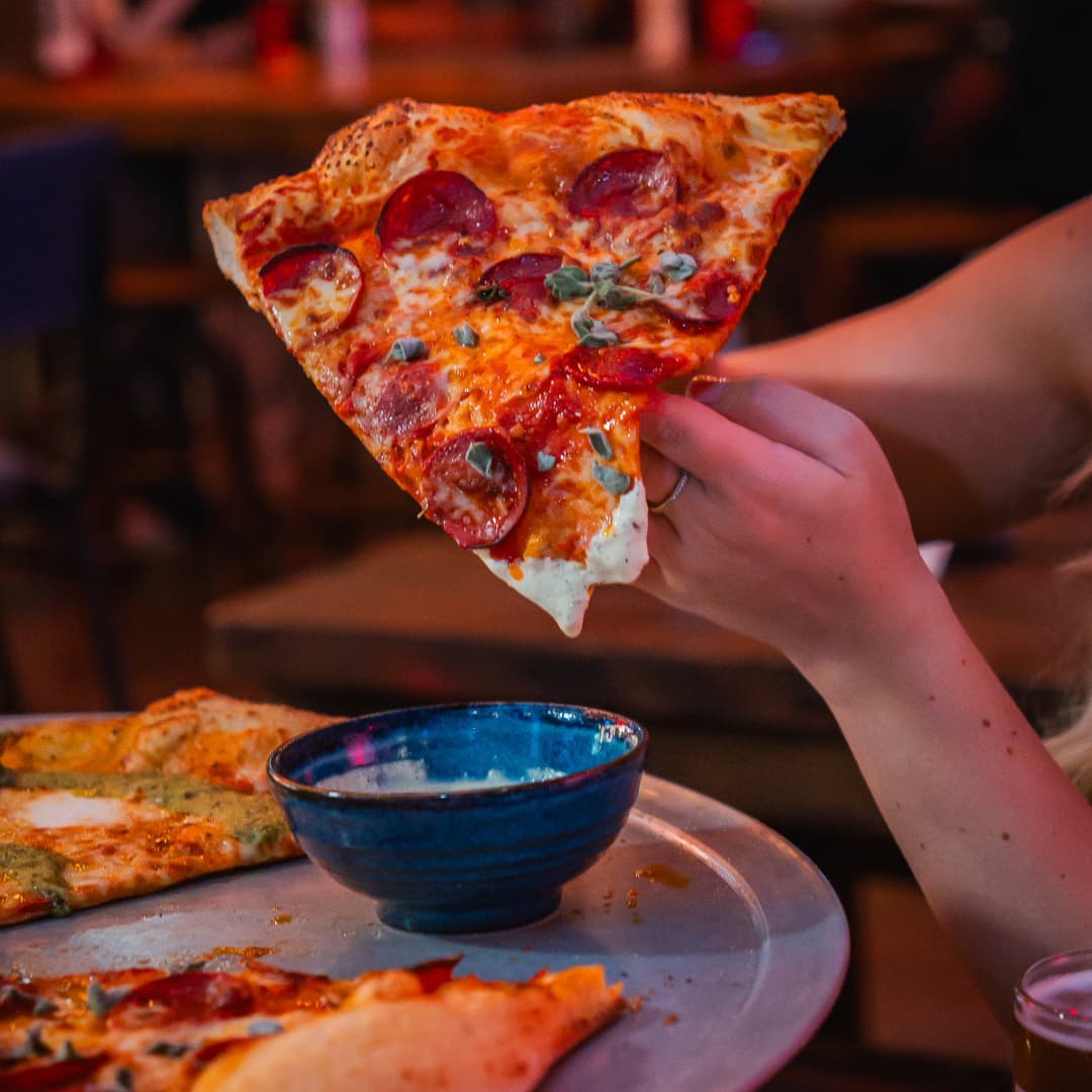 XL slice of pizza at Rita's Leeds