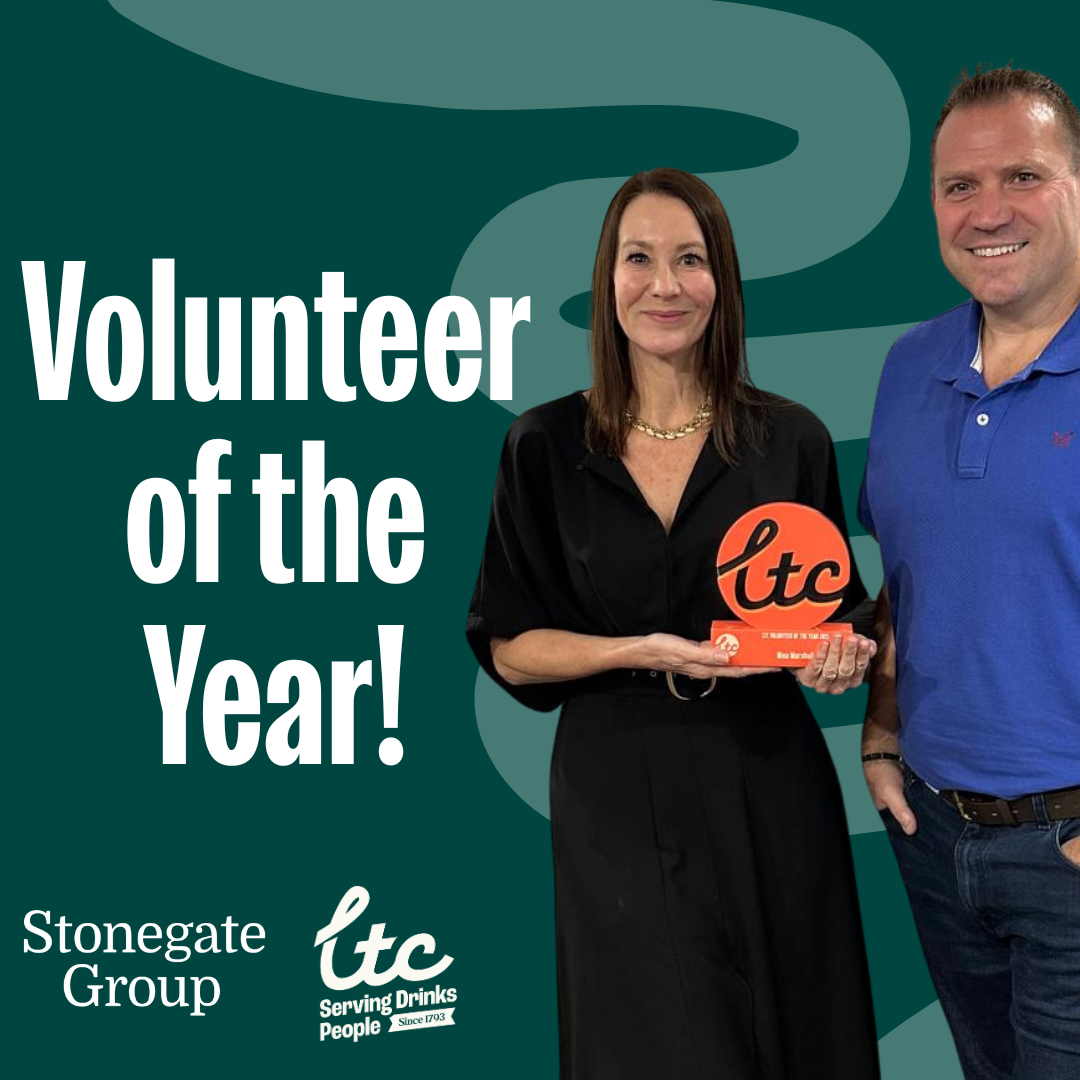 Image of Nina Marshall being presented with her 'Volunteer of the Year' award on a green background with accompanying text 'Volunteer of the Year'