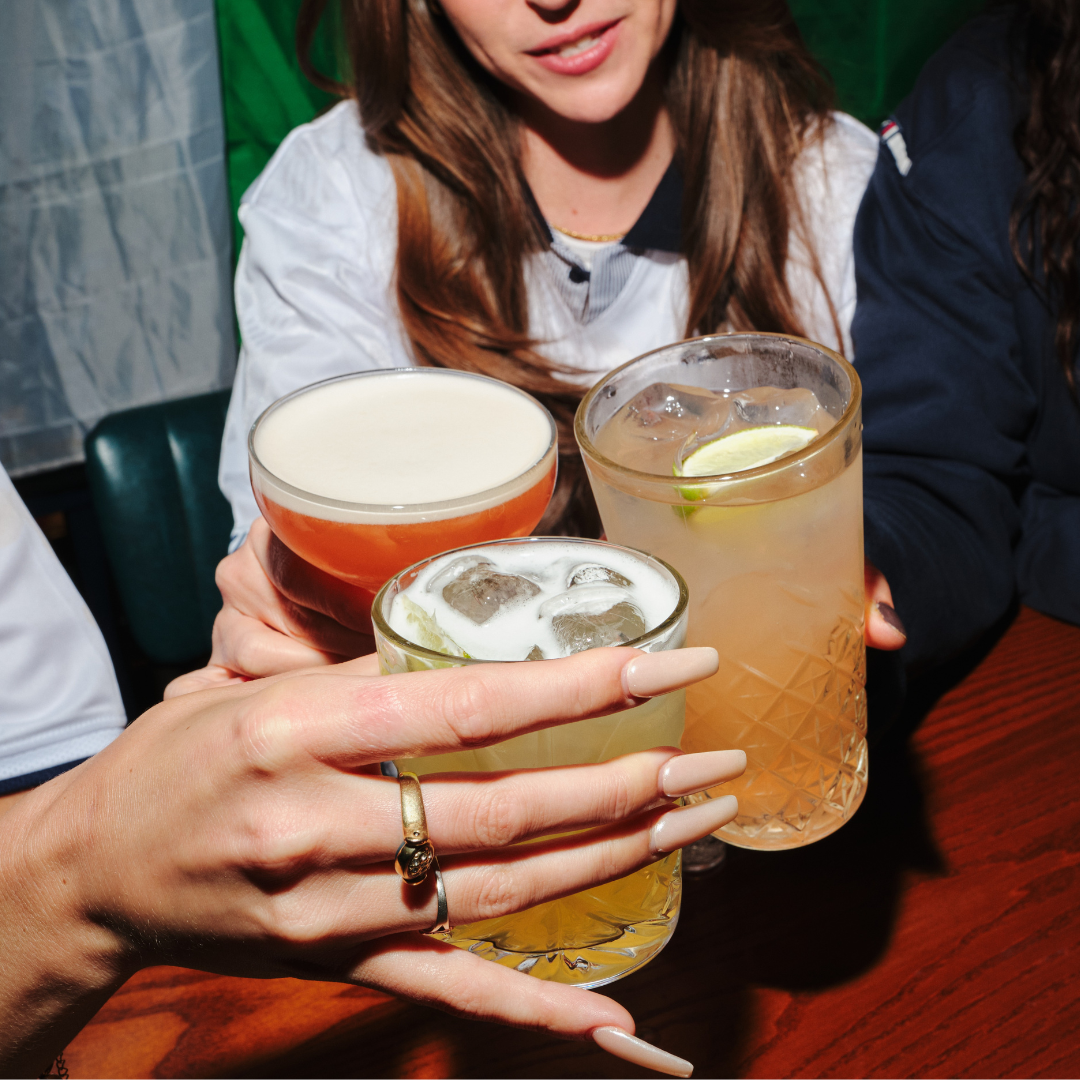 3 people cheersing drinks