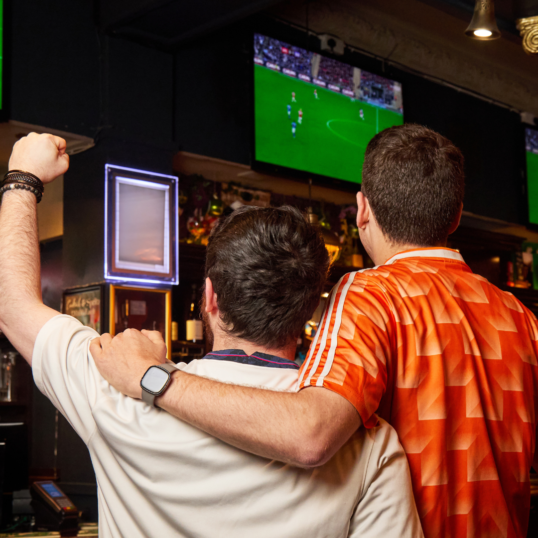 2 people watching football match
