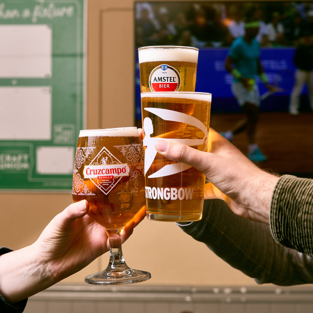 3 people cheersing pints