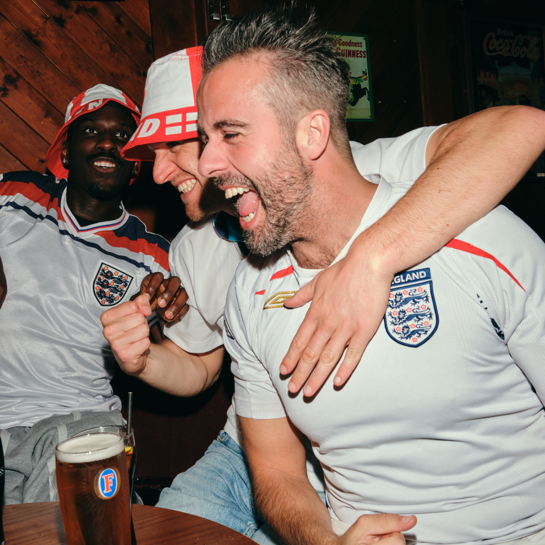 Group of people gathered around a table for world cup games
