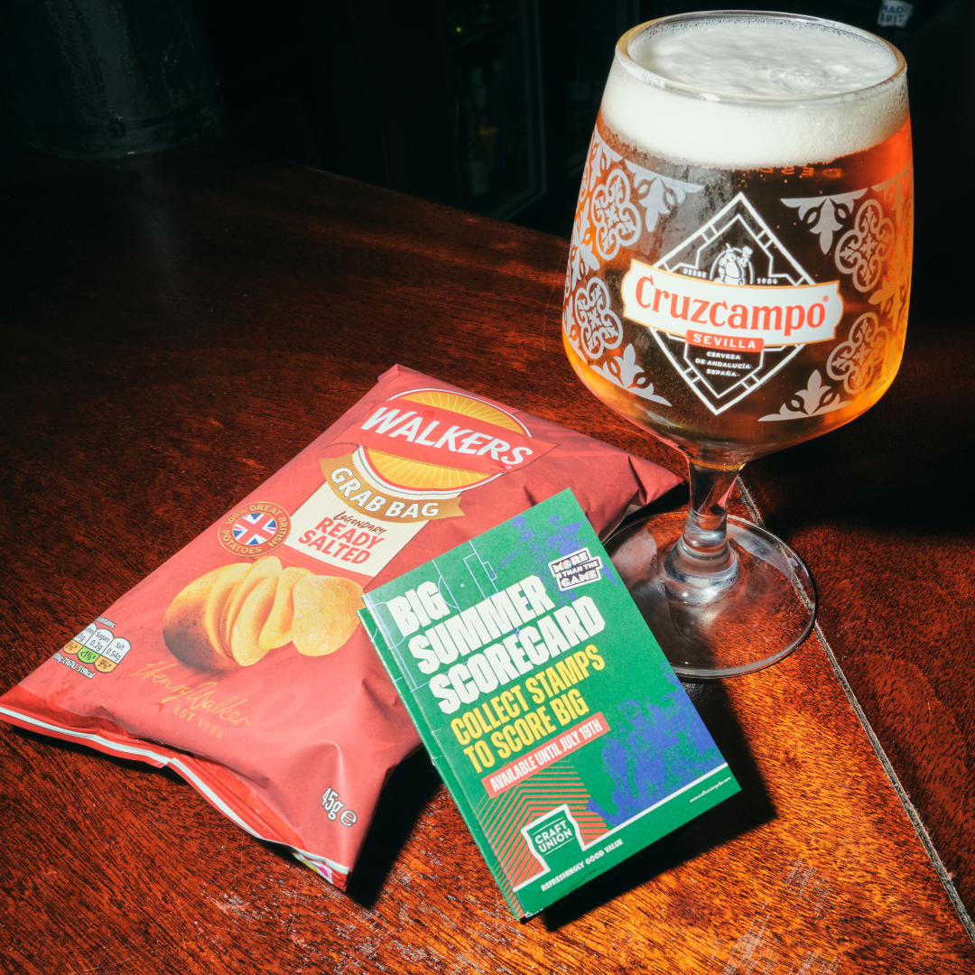 Pint of cruzcampo, walkers crisps and a summer scorecard