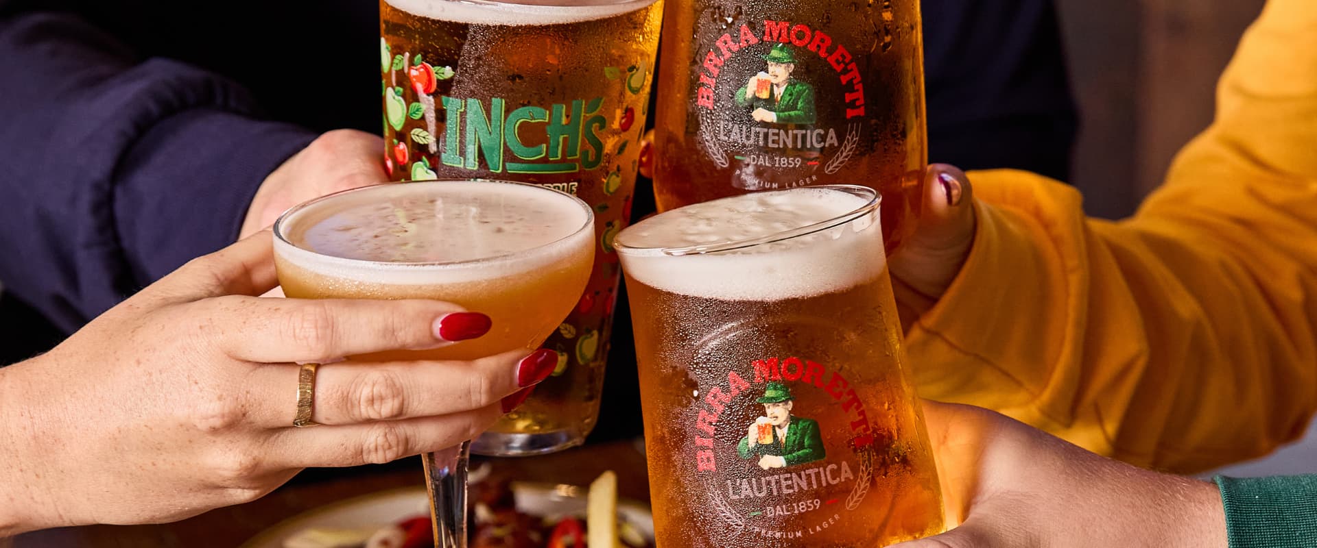 4 people cheersing drinks at Walkabout