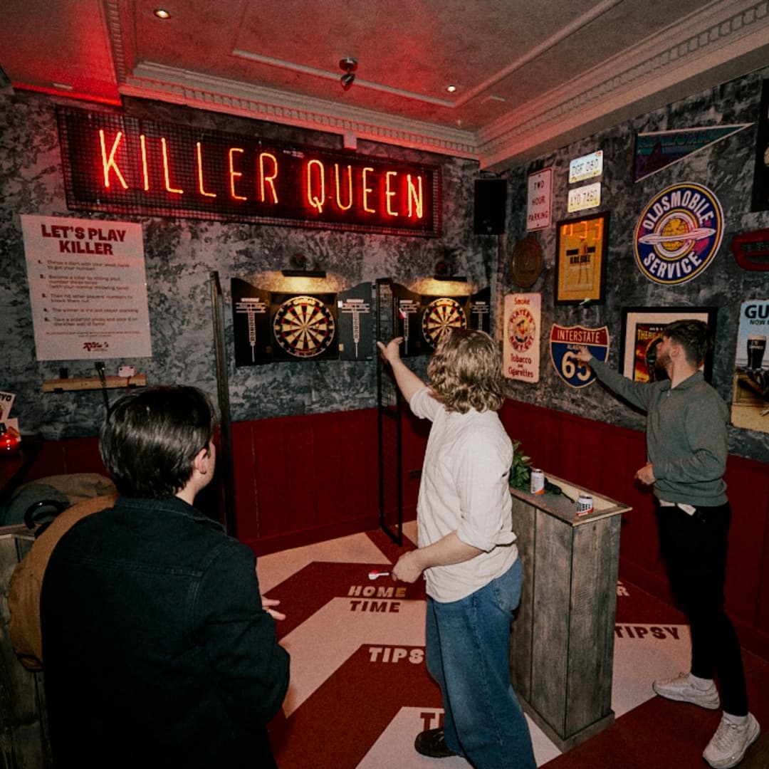 Playing darts at Rita's Leeds