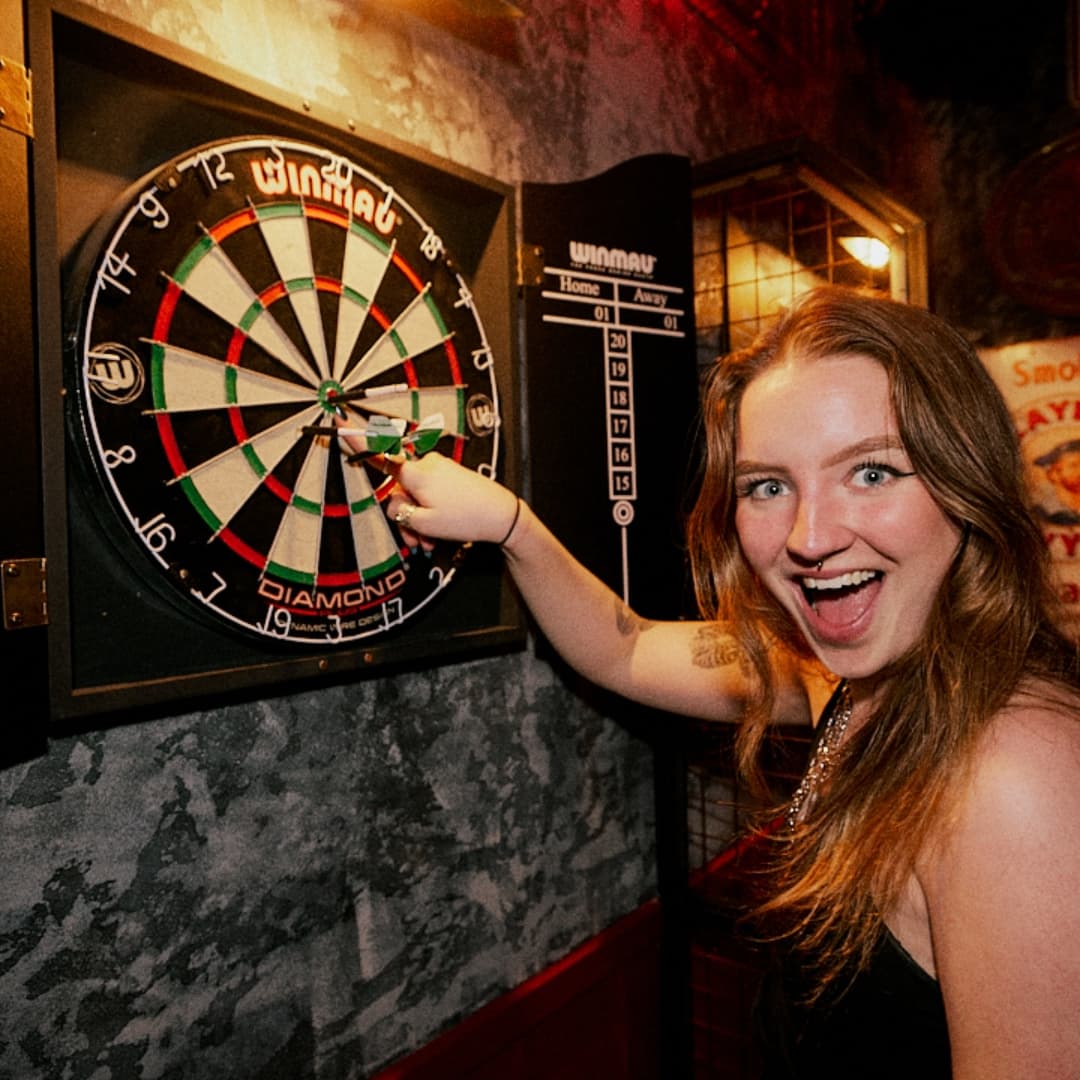 Playing darts at Rita's Leeds