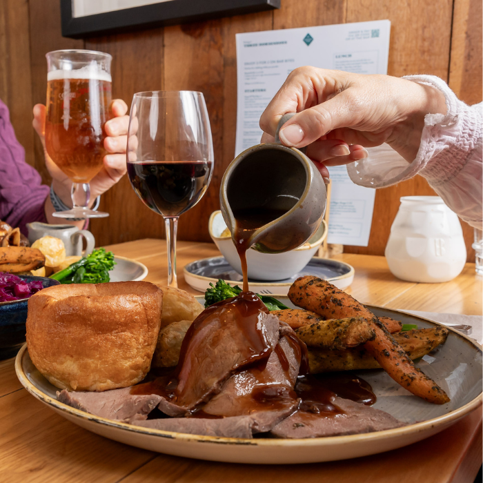 Pouring gravy onto sunday dinner