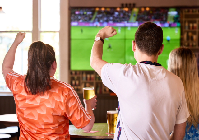 Fans watching football at The People's Pub