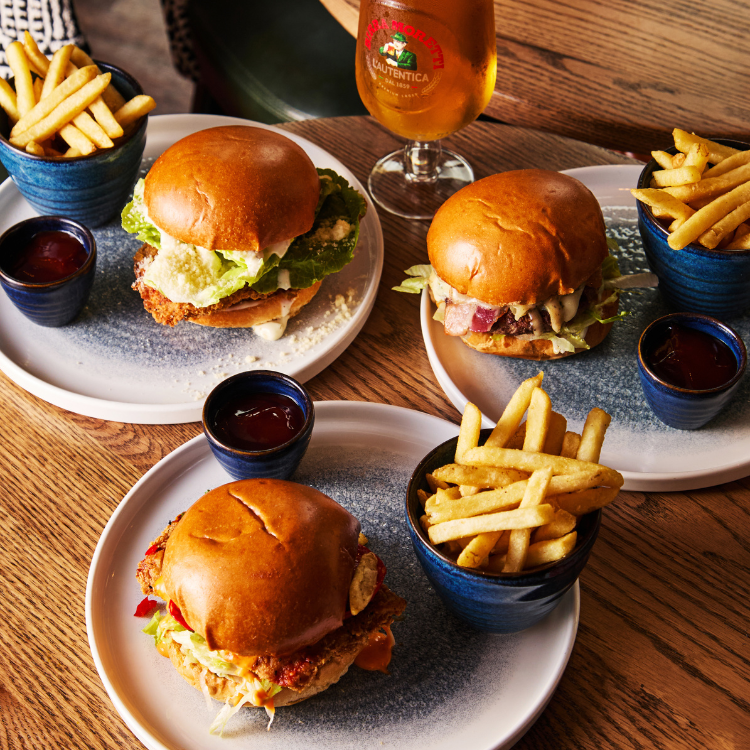 3 burgers and fries on table