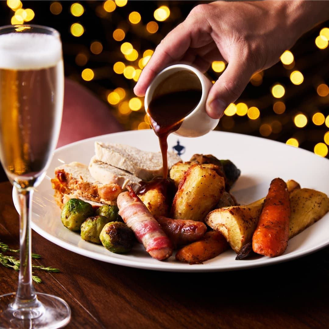 Christmas Roast Dinner, Pouring Gravy Over Food