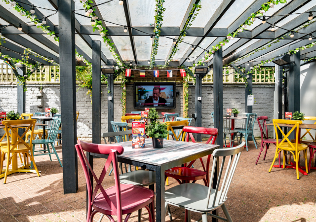 Outdoor beer garden with TVs and shelter