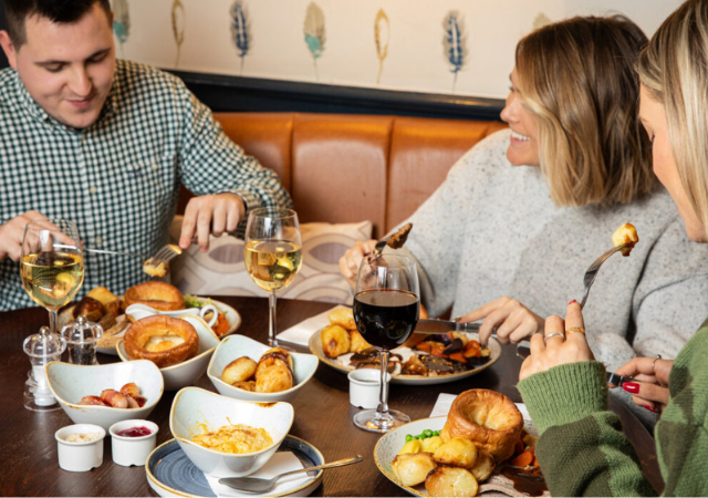 image of a group of people enjoying a sunday roast in a pub