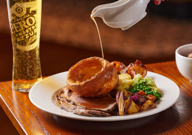 image of a group of people enjoying a sunday roast in a pub