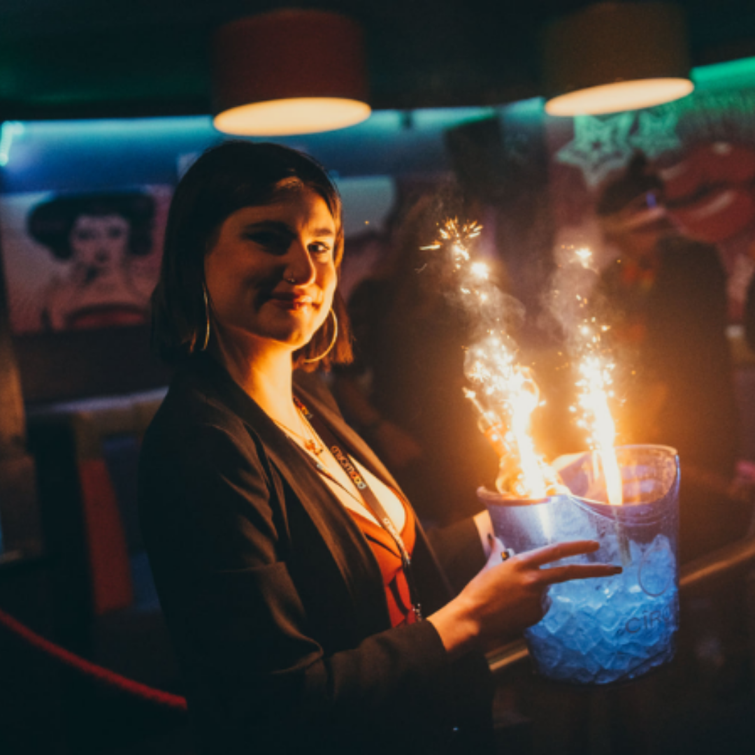 Popworld team member holding an ice bucket with sparklers