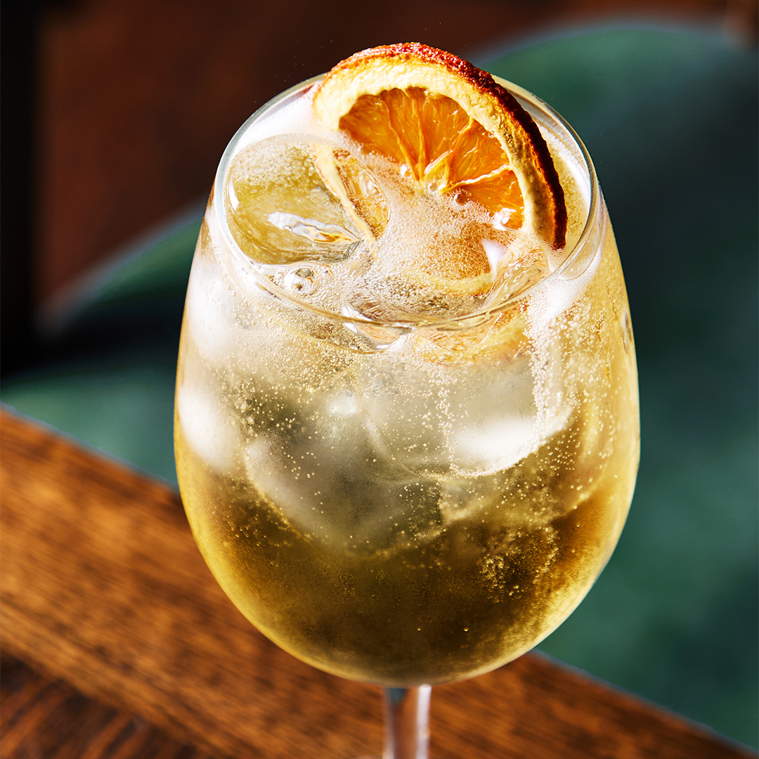 Spritz cocktail with orange wheel