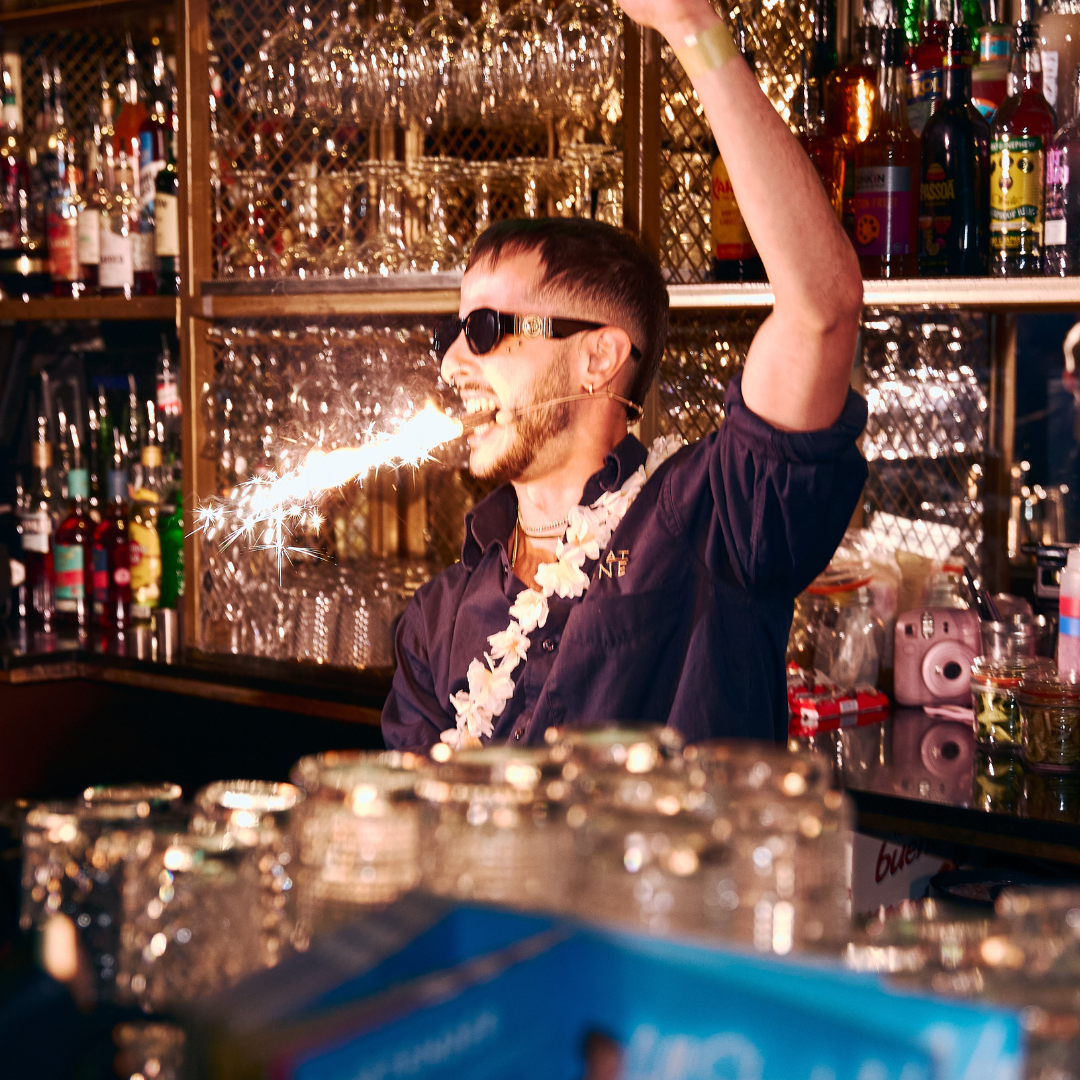 Bartender with sparkler in his mouth