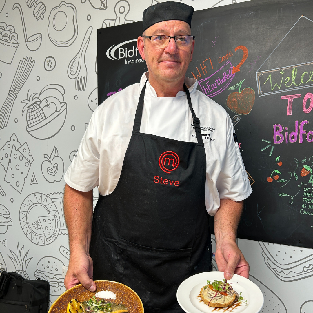 Masterchef finalist, Steve holding his two final dishes