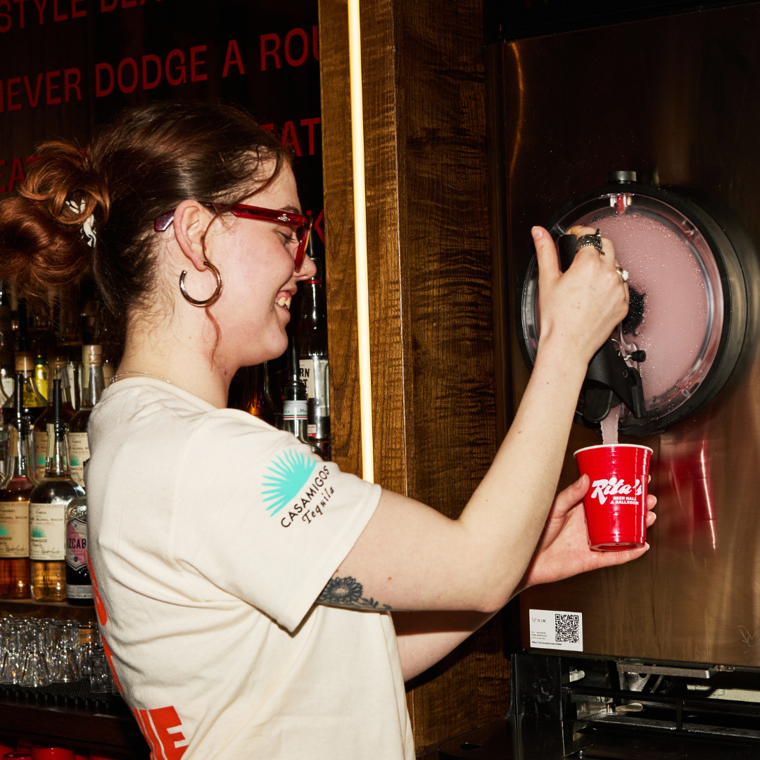 Rita's Team Member pouring a frozen margarita.