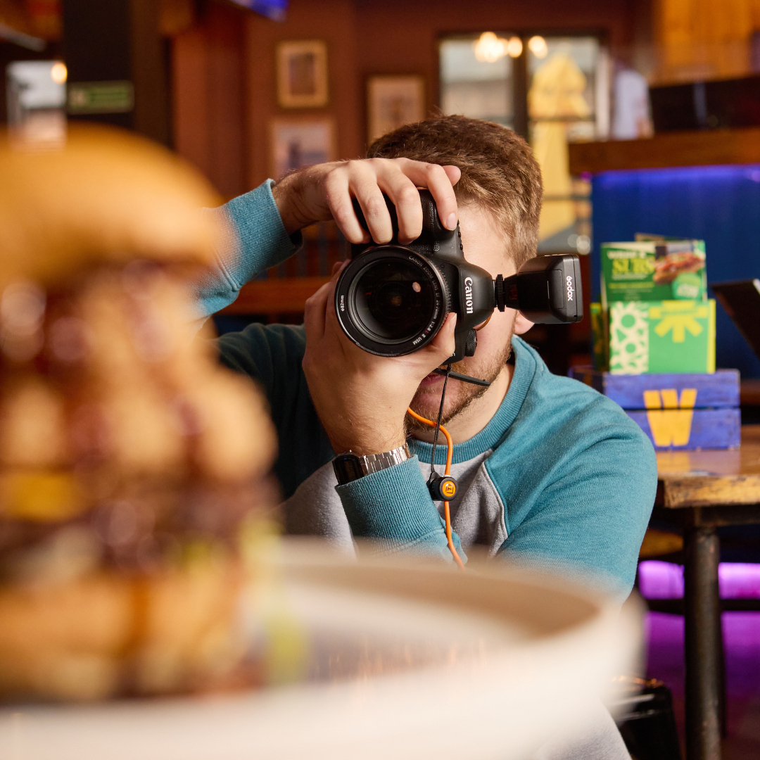Photographer shooting a burger in a Walkabout.
