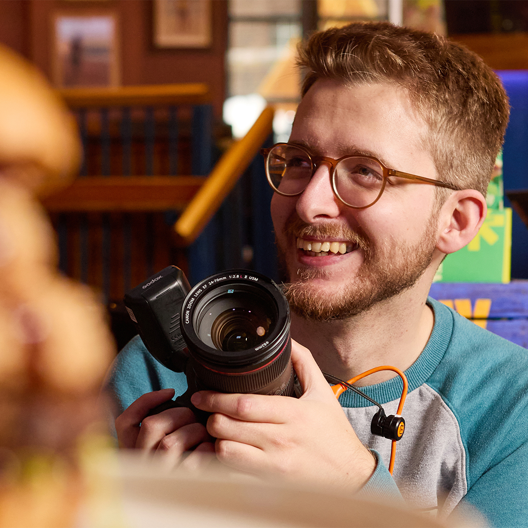 Photographer smiling away from the camera