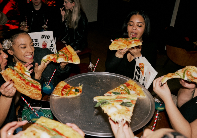 Group enjoying Rita's 24" Pizza