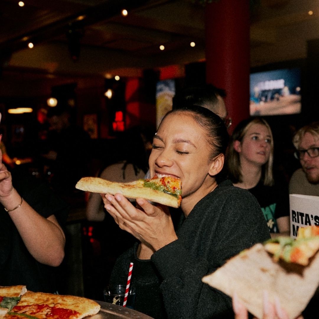 Someone enjoying their slice at Rita's